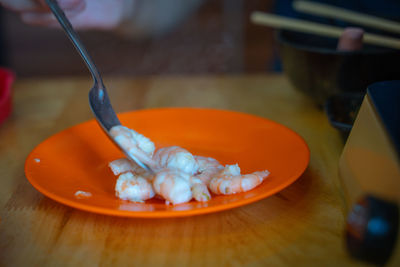 Close-up of orange slice in plate on table