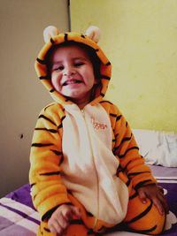 Portrait of cute boy on bed at home