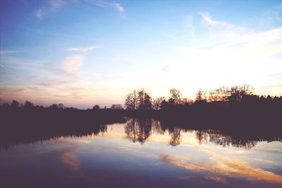 Scenic view of calm lake at sunset