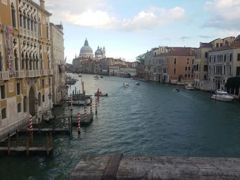 Boats in canal along buildings