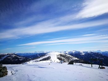 Scenic view of snowcapped mountains against blue sky