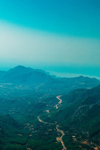 Aerial view of landscape and mountains against clear sky