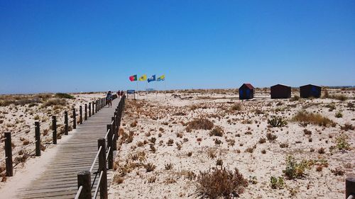 Long narrow jetty on sandy beach