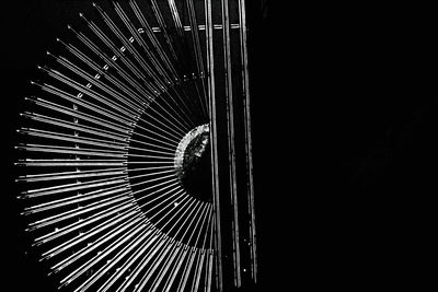 Low angle view of illuminated lighting equipment in darkroom