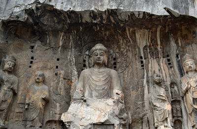 Low angle view of statue against historic building