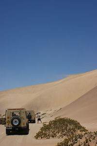 View of desert against clear blue sky