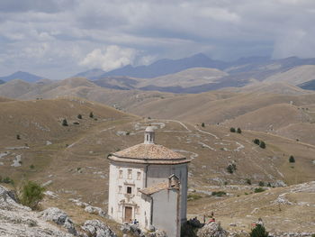 High angle view of church against cloudy sky