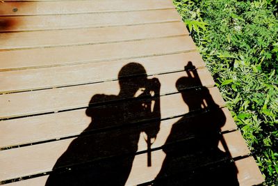 Shadow of man photographing on wall