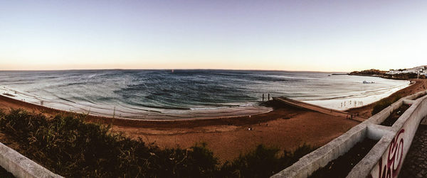 Panoramic view of beach against clear sky during sunset