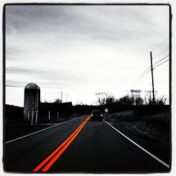 Road passing through dramatic sky