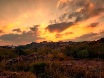 Scenic view of field against sky during sunset