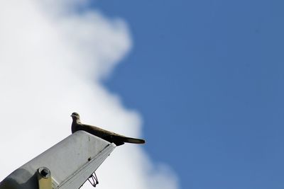 Low angle view of cross against blue sky