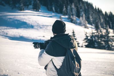 Rear view of man on snow land