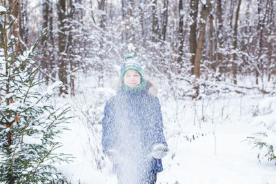 Portrait of person standing on snow covered land