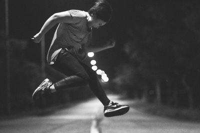 Woman jumping on street