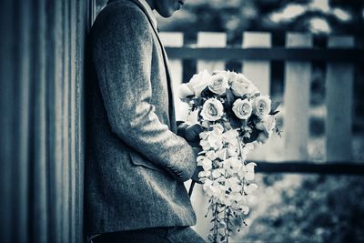 Close-up of man standing by railing
