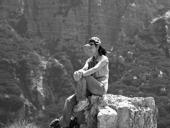 Woman sitting on rock