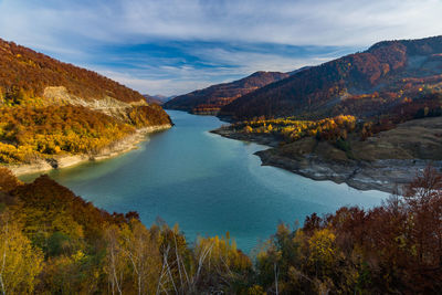 Scenic view of lake and mountains against sky during autumn