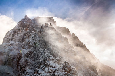 Low angle view of rock formation against sky