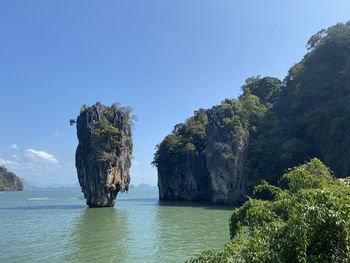 Scenic view of rock formation in sea against sky