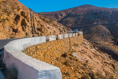 Scenic view of dam and mountains against sky