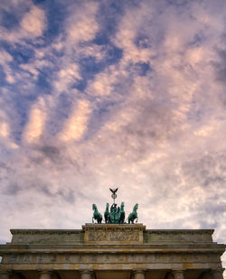 Low angle view of statue against cloudy sky