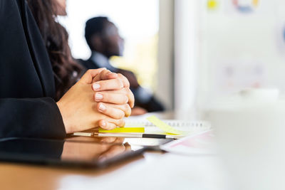 Close-up of woman holding hands on table