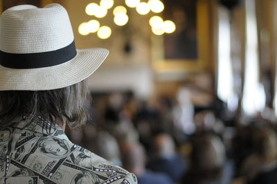 Rear view of  artist wearing hat