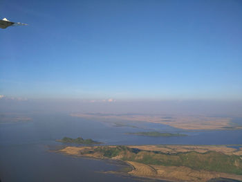 Scenic view of landscape against blue sky