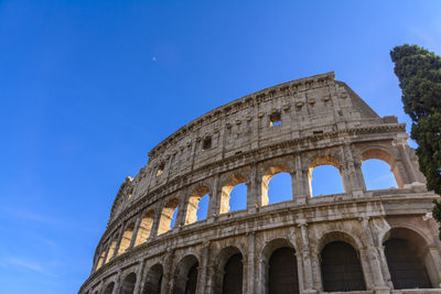 Low angle view of historical building against blue sky