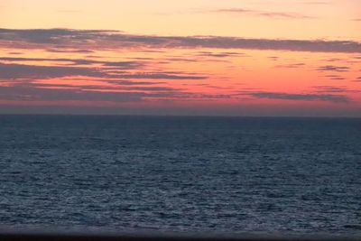 Scenic view of sea against romantic sky at sunset