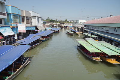 High angle view of boats moored at harbor in city