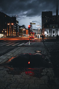 Illuminated city street and buildings at night