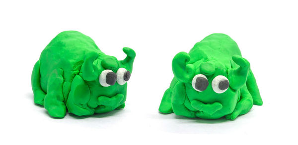 Close-up of green toy against white background