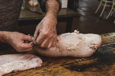 Cropped hands of person preparing food