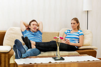 Man looking at angry woman at home