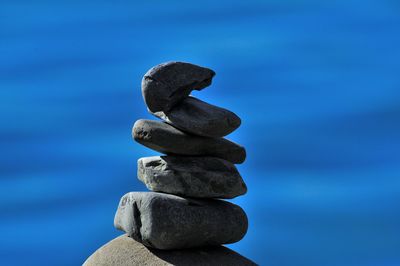 Stack of stones against blue sky