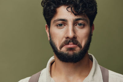 Close-up of young man looking away against black background