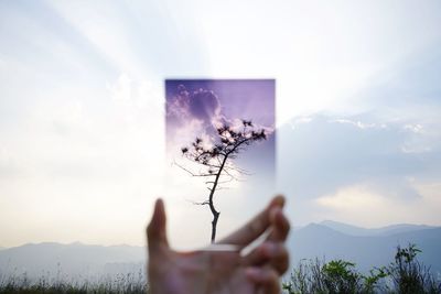 Man and woman on mountain against sky