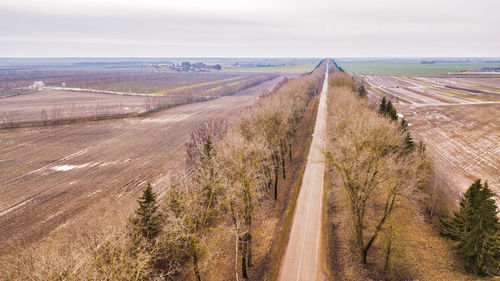 Panoramic shot of road amidst land against sky