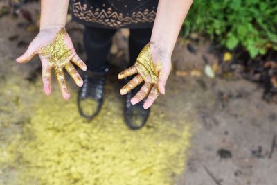 Cropped image of women with glitter on hand