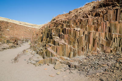 Scenic view of organ pipes rock formation against clear sky, namibia, africa