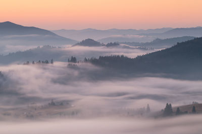 Scenic view of mountains against sky during sunrise