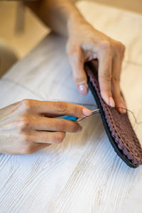 Cropped hands of woman working on table