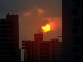 Low angle view of buildings against sky during sunset