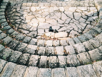 Close-up of camera on cobblestone ground