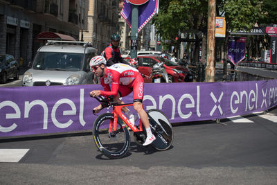 Man riding bicycle on street in city