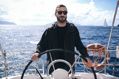 Portrait of young man sailing in sea