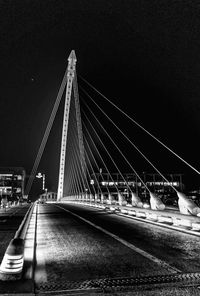 Illuminated bridge at night