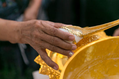 Close-up of hand holding orange